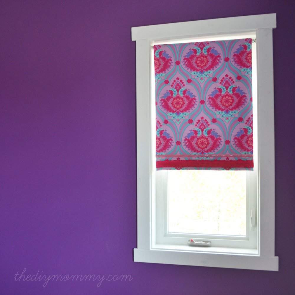 white window trim stands out in a purple painted room