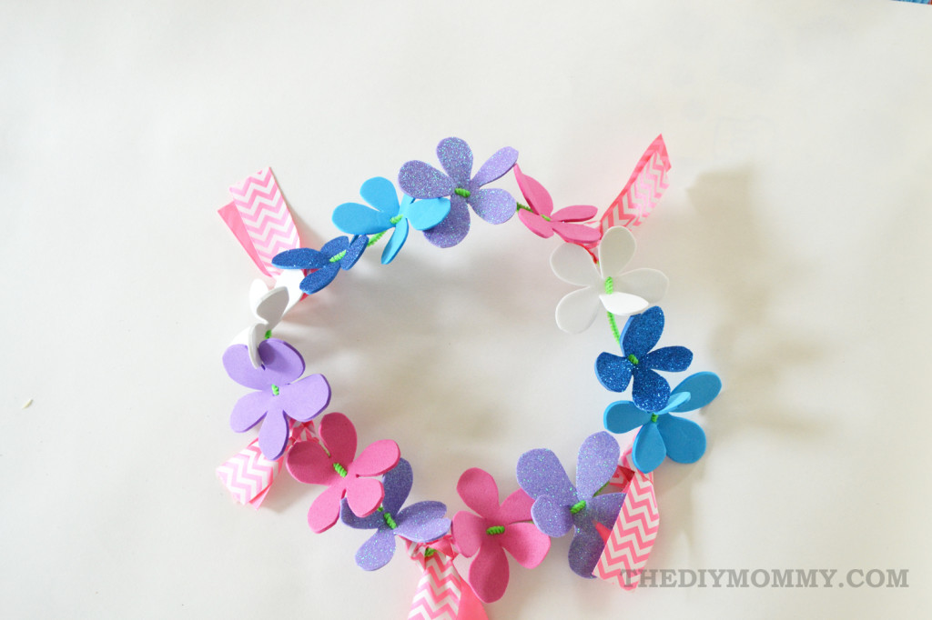 Make a floral crown from foam sheets, pipe cleaners and ribbon. The DIY Mommy.