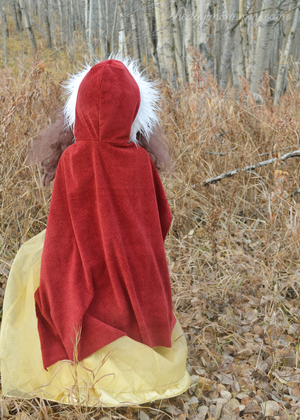 A person in a red cloak sitting in the woods. Perfect for sewing projects for kids. 