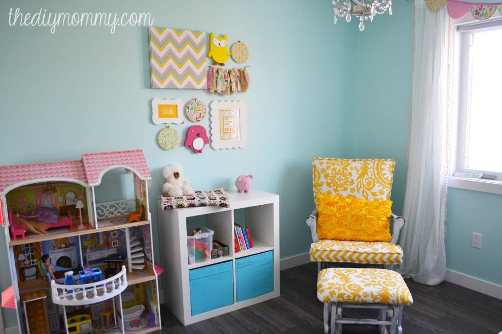 A Sunny Woodland Nursery. This sweet nursery is decorated in aqua, yellow, blush pink and chocolate brown and features a ton of inexpensive DIY decor elements.