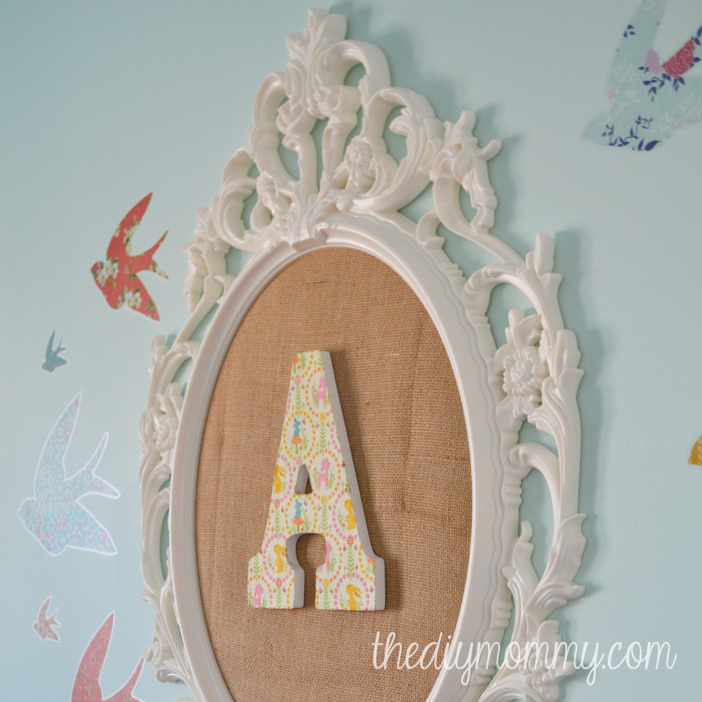 How to make DIY monogram wall art for a nursery or kid's room with burlap, and Ikea frame and scrap fabric.