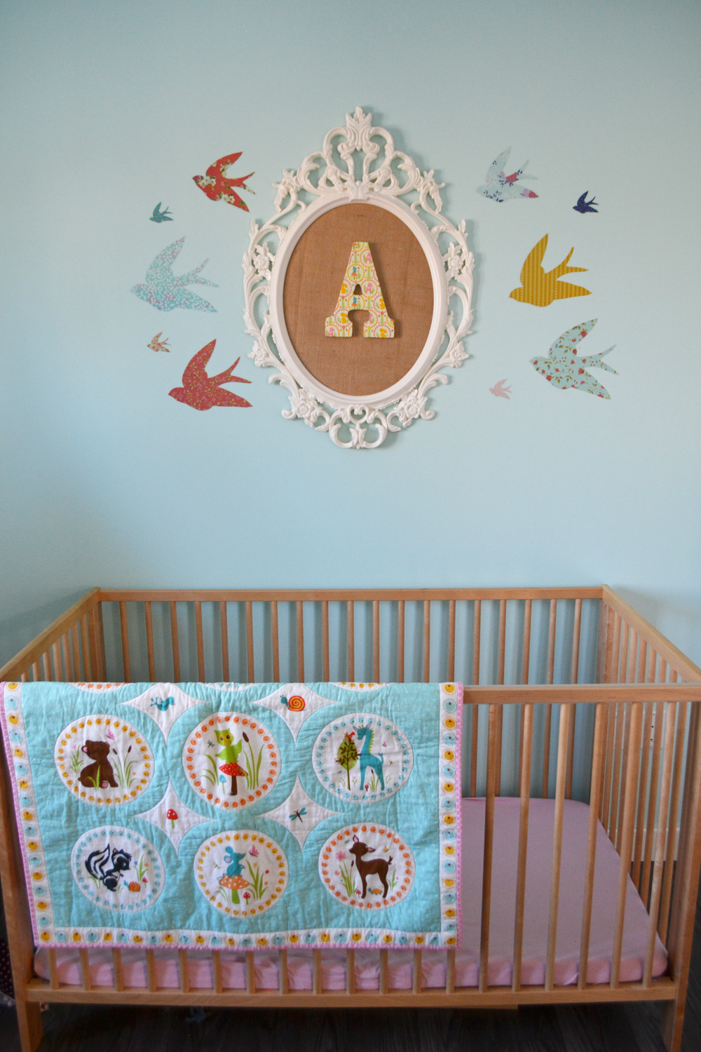 A Sunny Woodland Nursery. This sweet nursery is decorated in aqua, yellow, blush pink and chocolate brown and features a ton of inexpensive DIY decor elements.