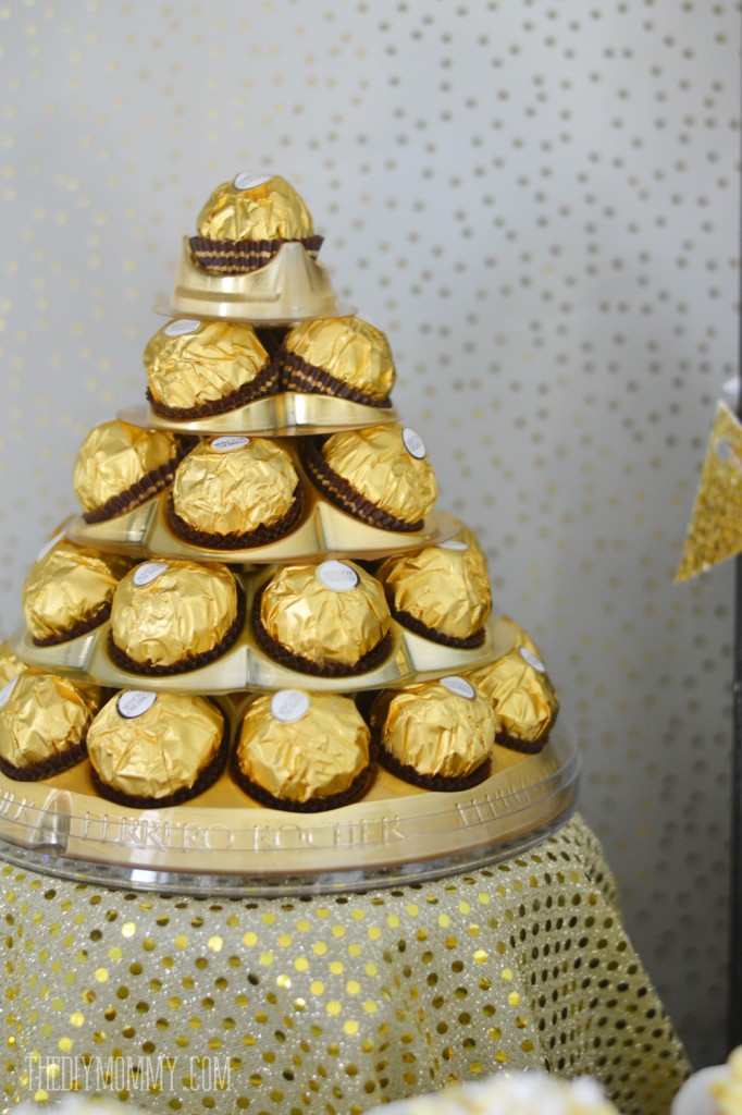 Gold and black glamorous Christmas or New Year's dessert table with Ferrero Rocher