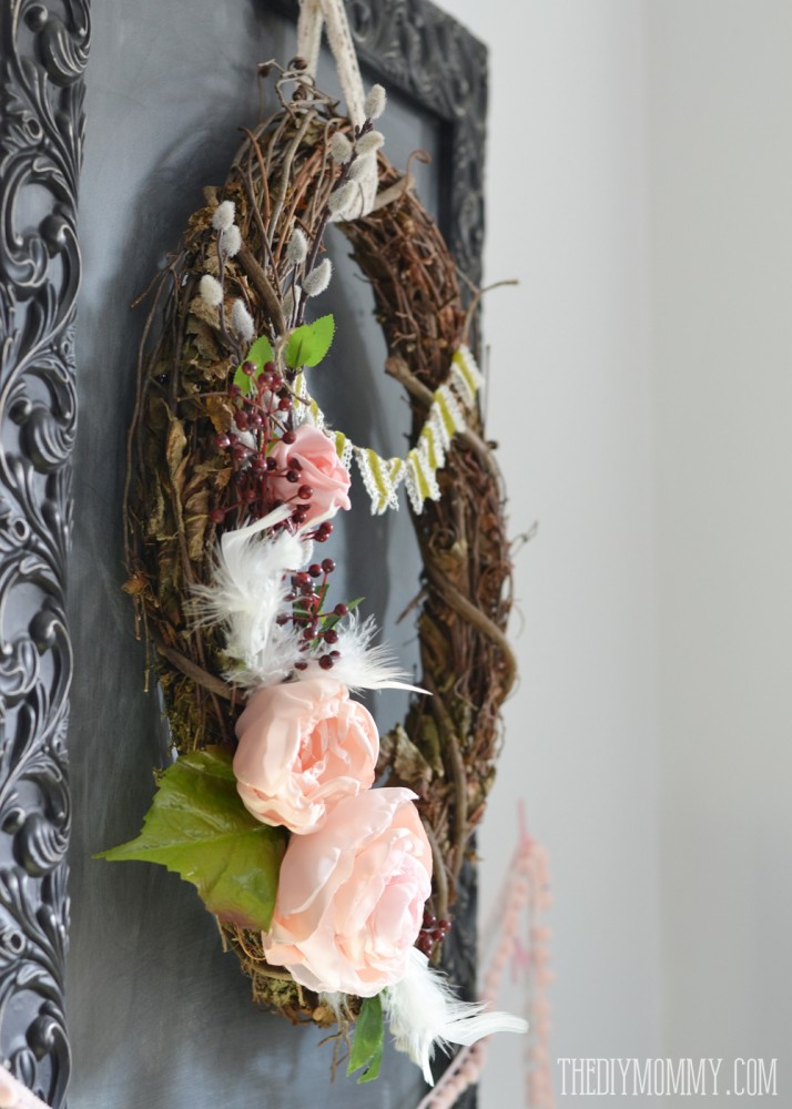 Gorgeous Spring wreath made from a grapevine wreath, DIY fabric roses, silk leaves, faux pussy willow and berry branches, boa feathers and a velvet ribbon banner.