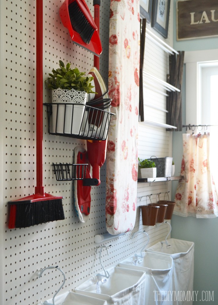 DIY aqua & red vintage inspired small laundry room design idea with a giant pegboard