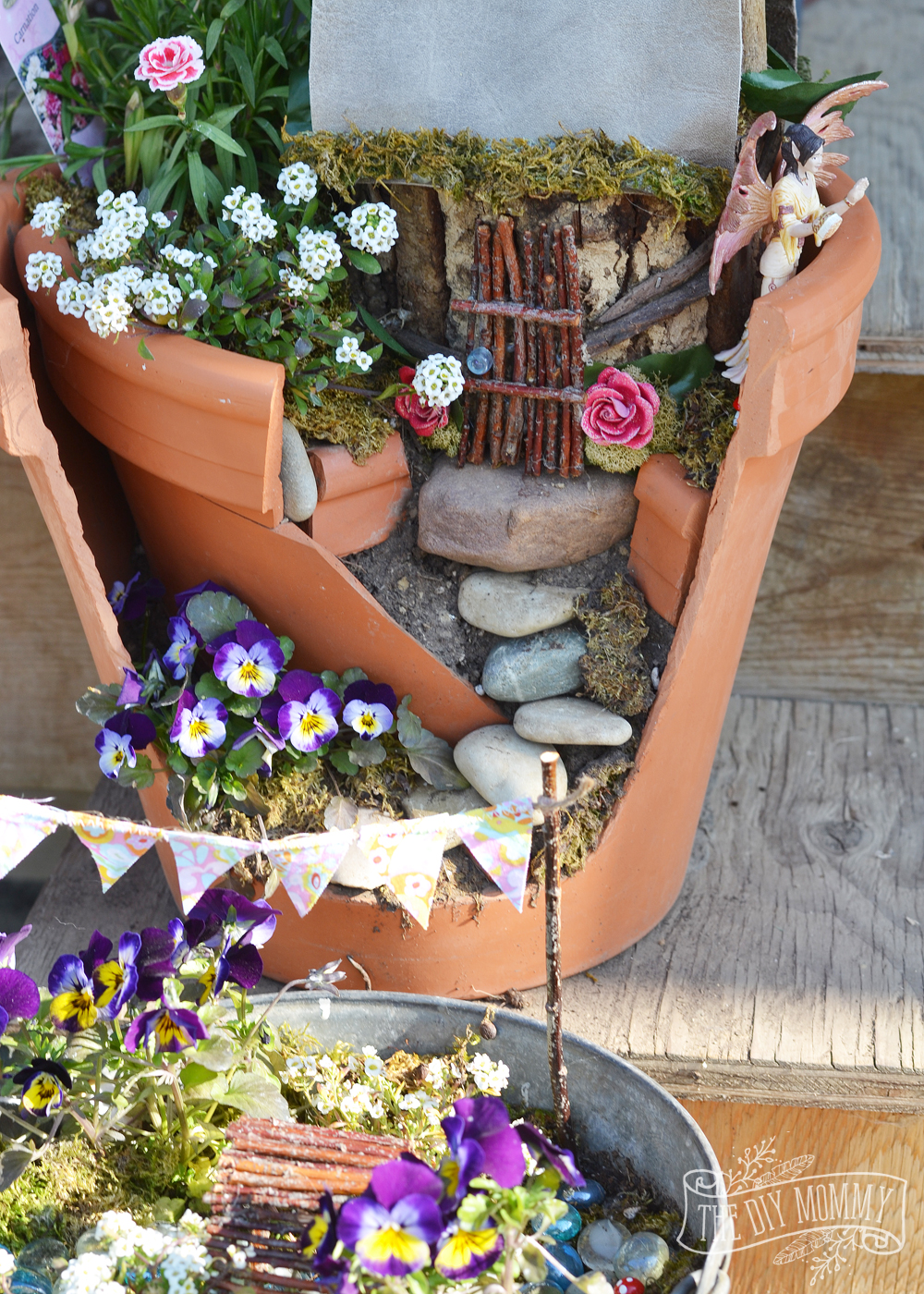 Easy + Inexpensive Fairy Garden: A broken pot, some props made of sticks, and some imagination make a sweet potted fairy garden that doesn't break the bank!
