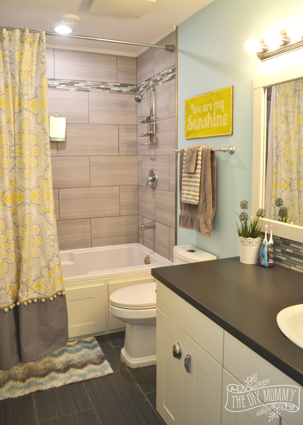 Yellow, gray and aqua kids bathroom design with great DIY ideas!