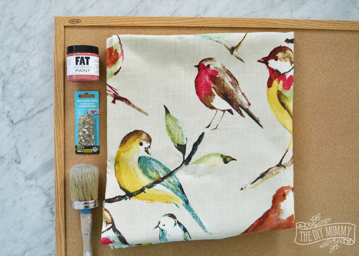 How to make a covered bulletin board with paint, fabric and brass upholstery tacks.