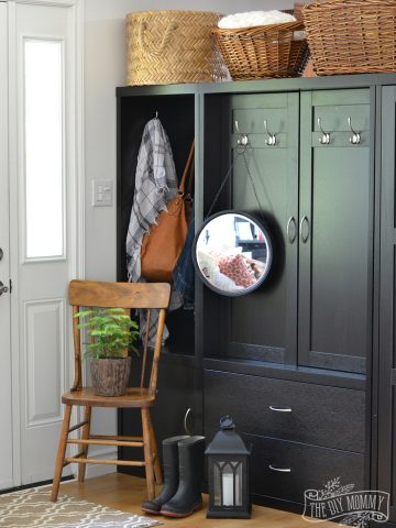 Use a storage or coat cabinet as a room divider to create an entry - black, white and wood farmhouse cottage entryway