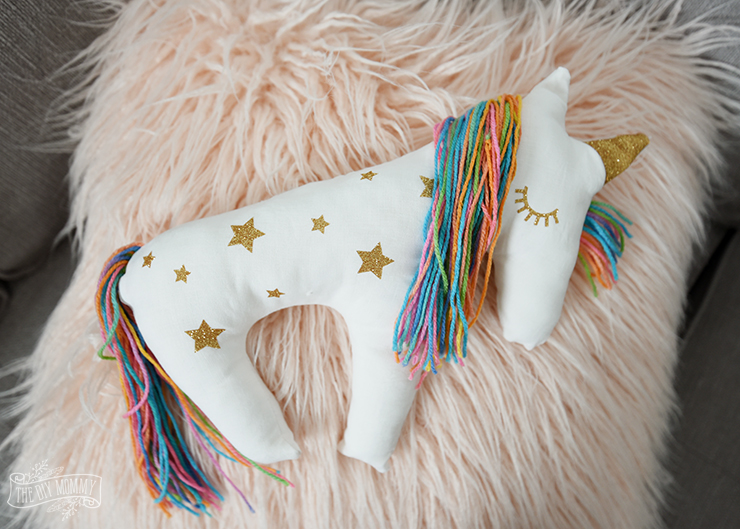 A little white DIY Unicorn Plush Pillow - covered in gold stars and has a rainbow mane.
A little white DIY Unicorn Plush Pillow - covered in gold stars and has a rainbow mane.