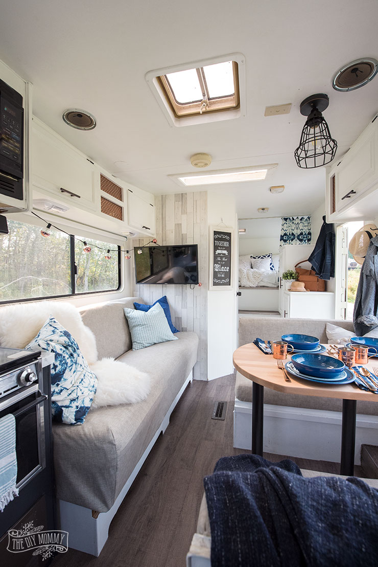 Our DIY Camper - Gorgeous, renovated RV tour with DIY paint job, vinyl plank flooring, reupholstered cushions, new hardware, updated lighting
