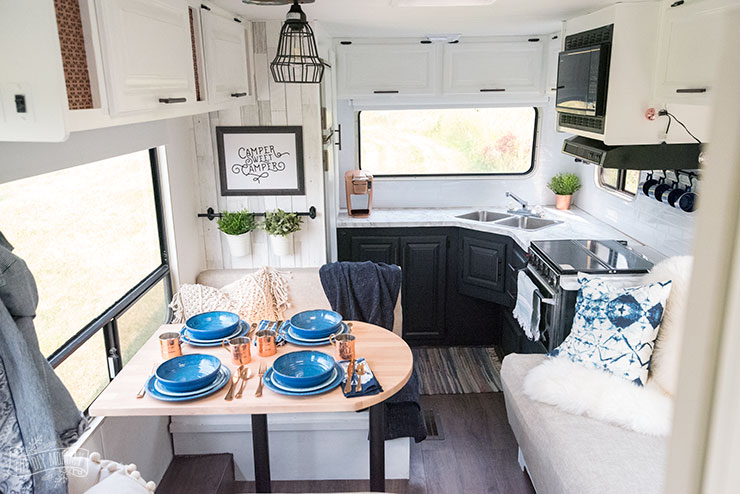 Our DIY Camper - Gorgeous, renovated RV tour with DIY paint job, vinyl plank flooring, reupholstered cushions, new hardware, updated lighting