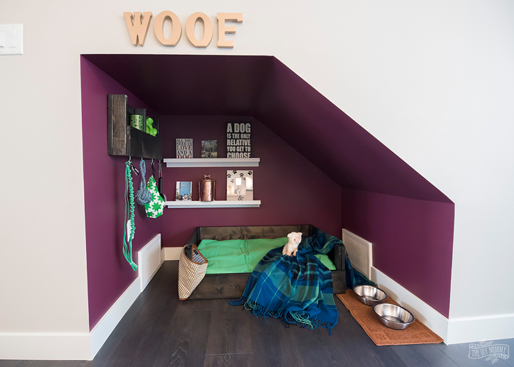 DIY dog nook under the stairs with handmade dog bed and organizer