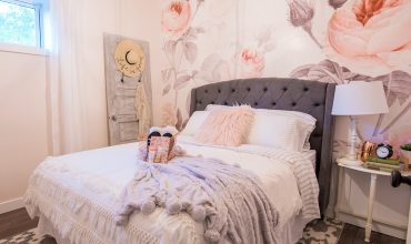 Feminine Modern Farmhouse Guest Bedroom Makeover with large floral wall mural, upholstered headboard, and blush pink, grey and copper colors
