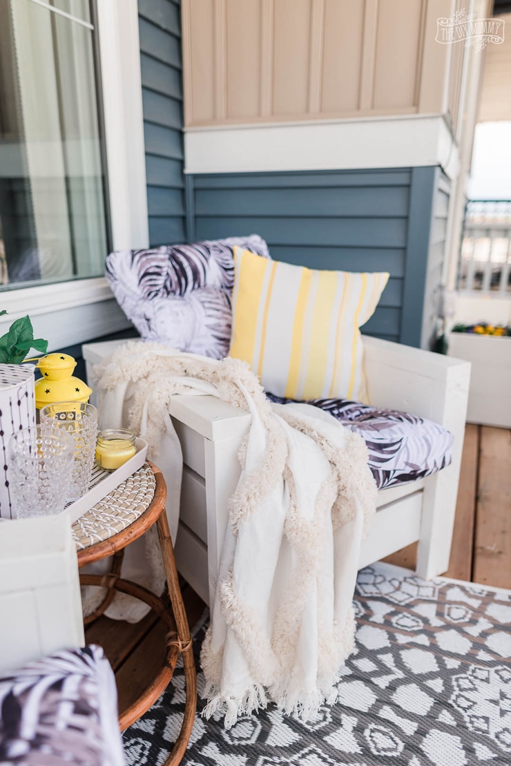 This front porch makeover with DIY outdoor chairs features bright yellow accents and handmade planter boxes. Get ideas for small front porch decorating!