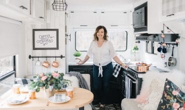 Budget renovation of a 1990s fifth wheel travel trailer with paint, fabric, wallpaper, and hardware