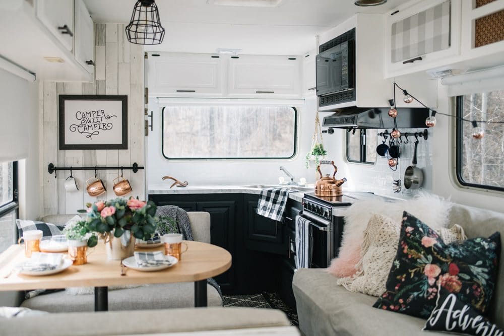 Budget renovation of a 1990s fifth wheel travel trailer with paint, fabric, wallpaper, and hardware