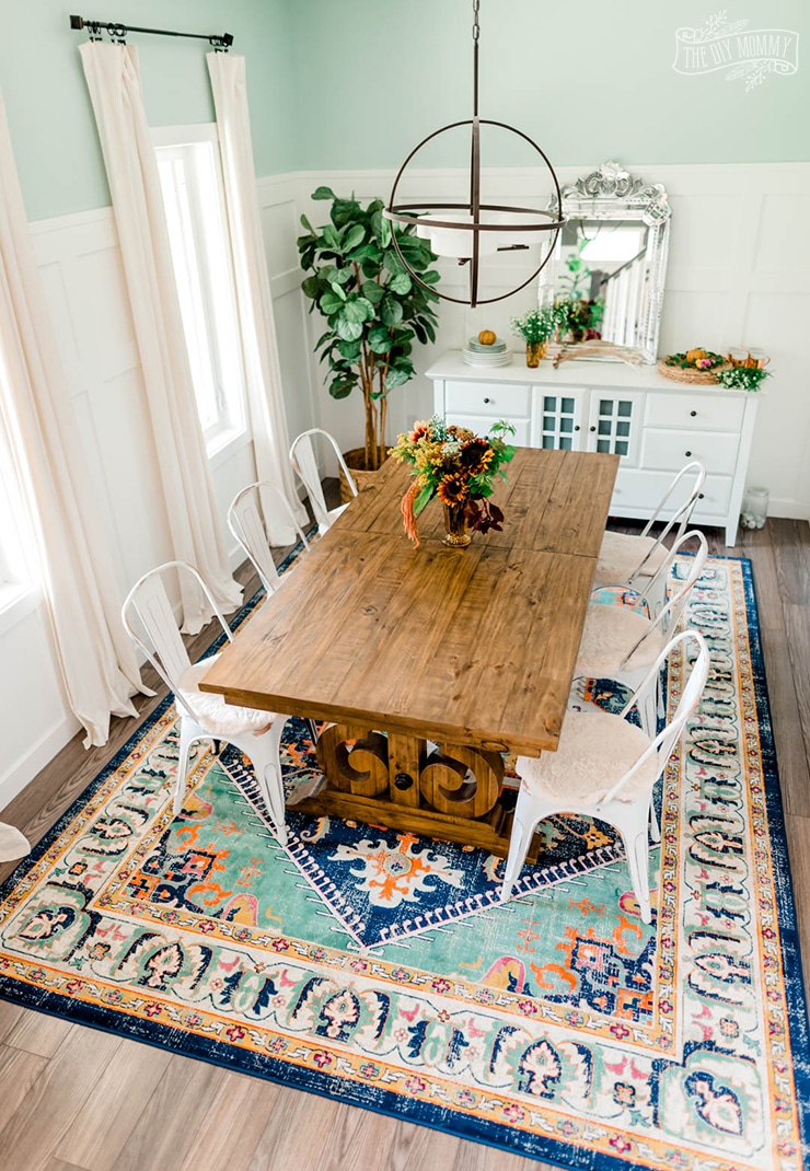 Dining room with colorful persian rug in green, pink, yellow, orange and blue