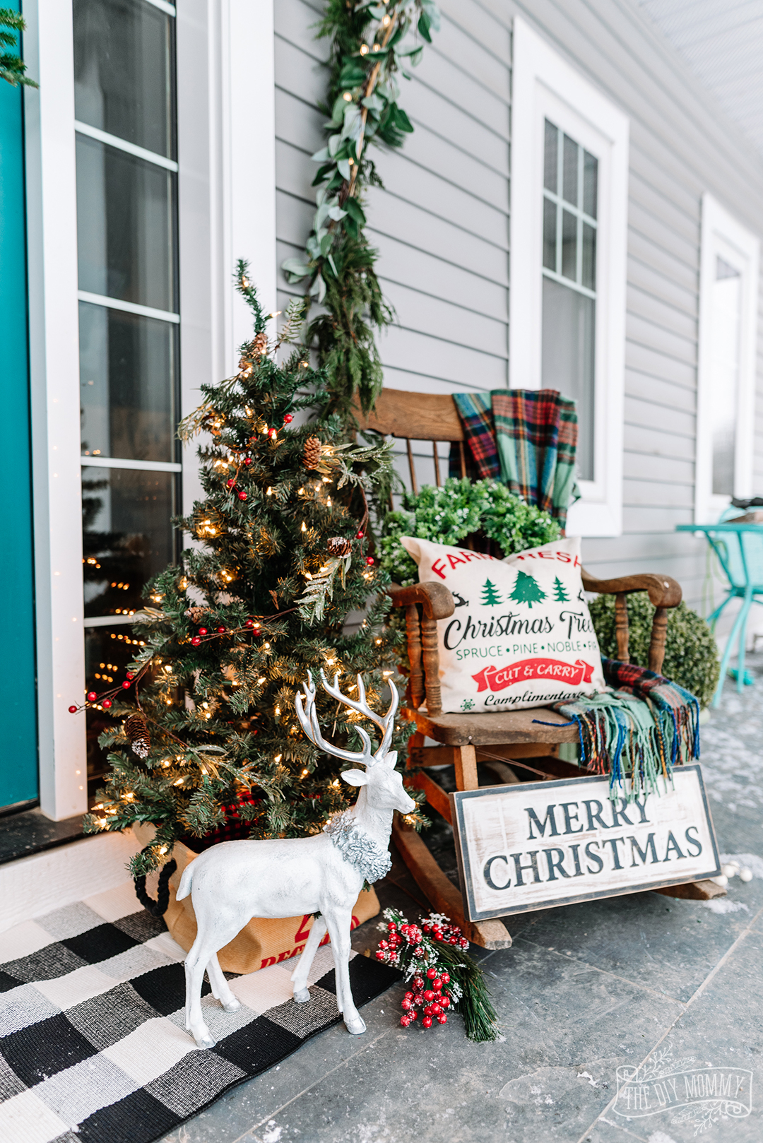 Christmas front porch in traditional farmhouse decor in reds, greens and teal colors