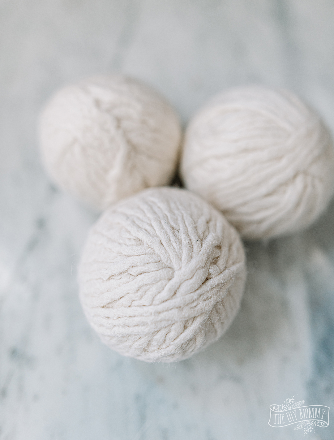 How to make DIY dryer balls from wool yarn. SO easy, reusable and works wonders in the laundry!