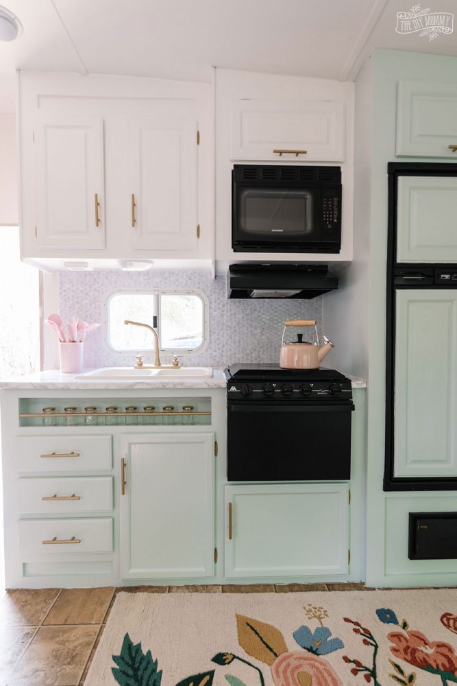 Glam RV Kitchen Makeover with white paint, mint green paint, and metallic gold accents