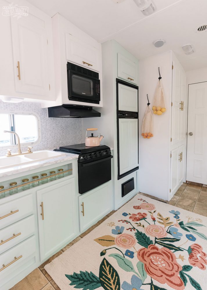 Glam RV Kitchen Makeover with white paint, mint green paint, and metallic gold accents