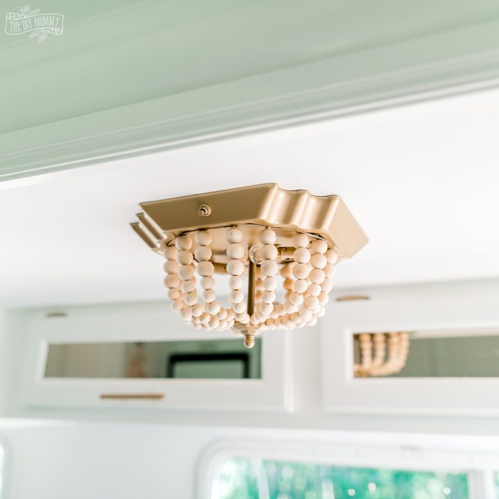 See how I transformed a flush mount fixture in our camper with this ceiling light DIY $7 boho makeover!