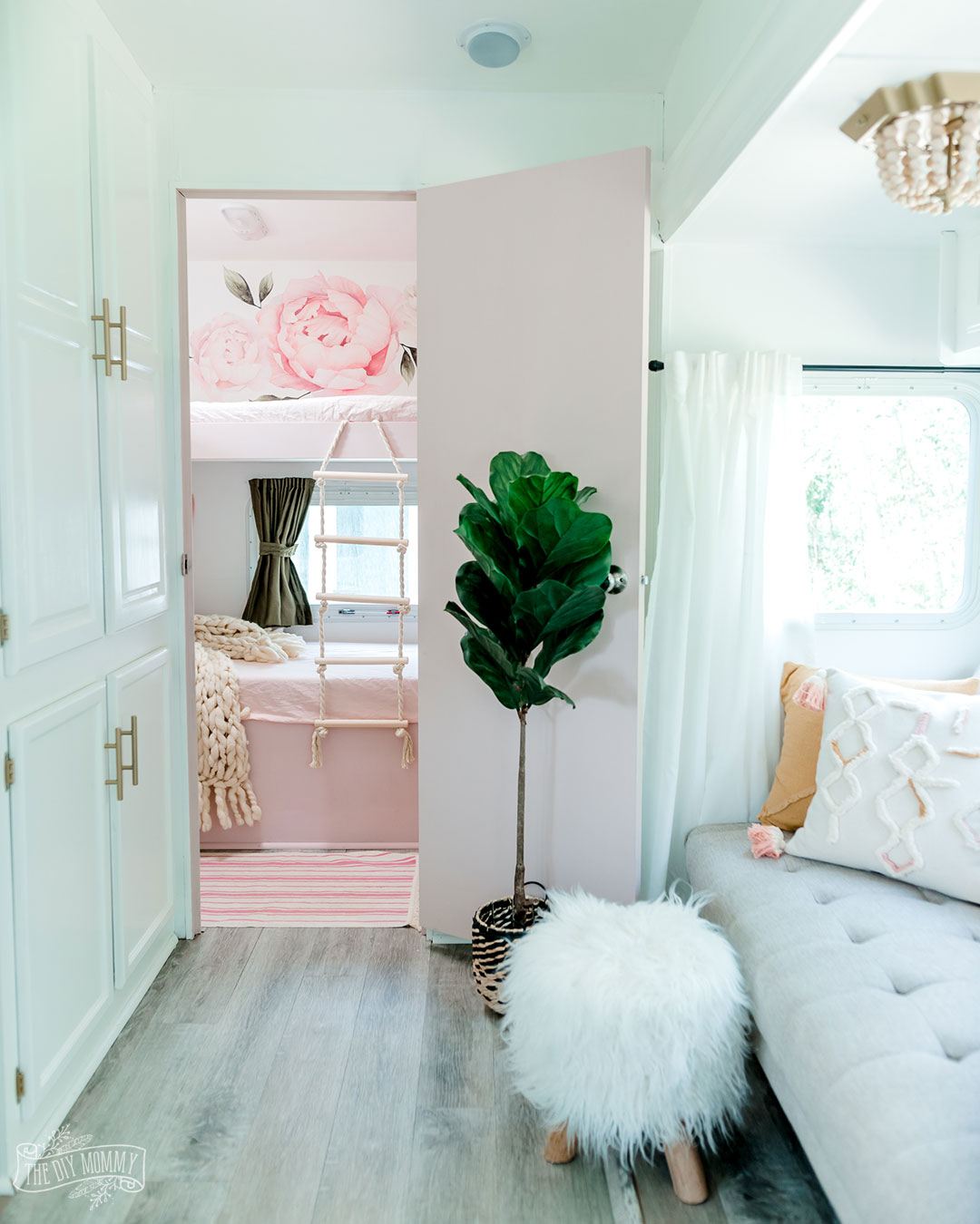 A dated RV bunk room is transformed into a pink & floral oasis for three girls.