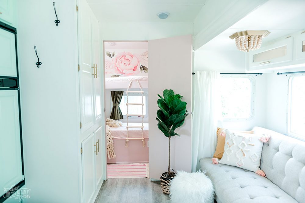 A dated RV bunk room is transformed into a pink & floral oasis for three girls.