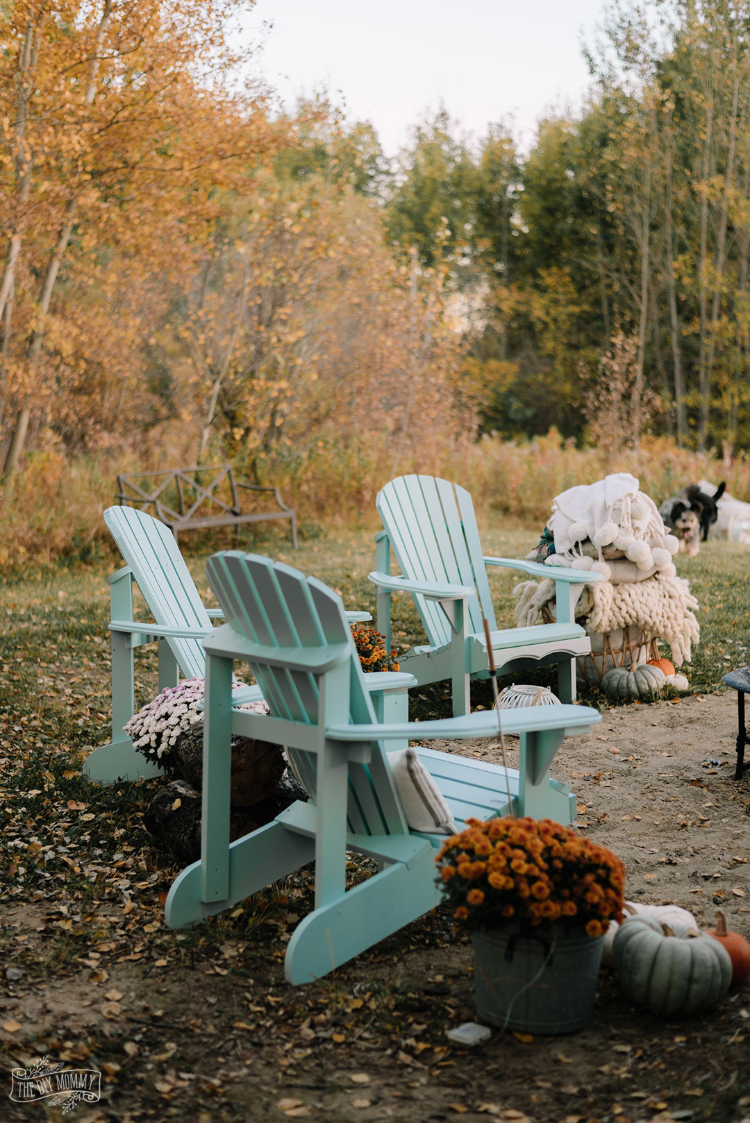 Cozy bakyard fire pit area with DIY Muskoka chairs, upcycled fire pit, s'mores station and cozy textiles for Fall