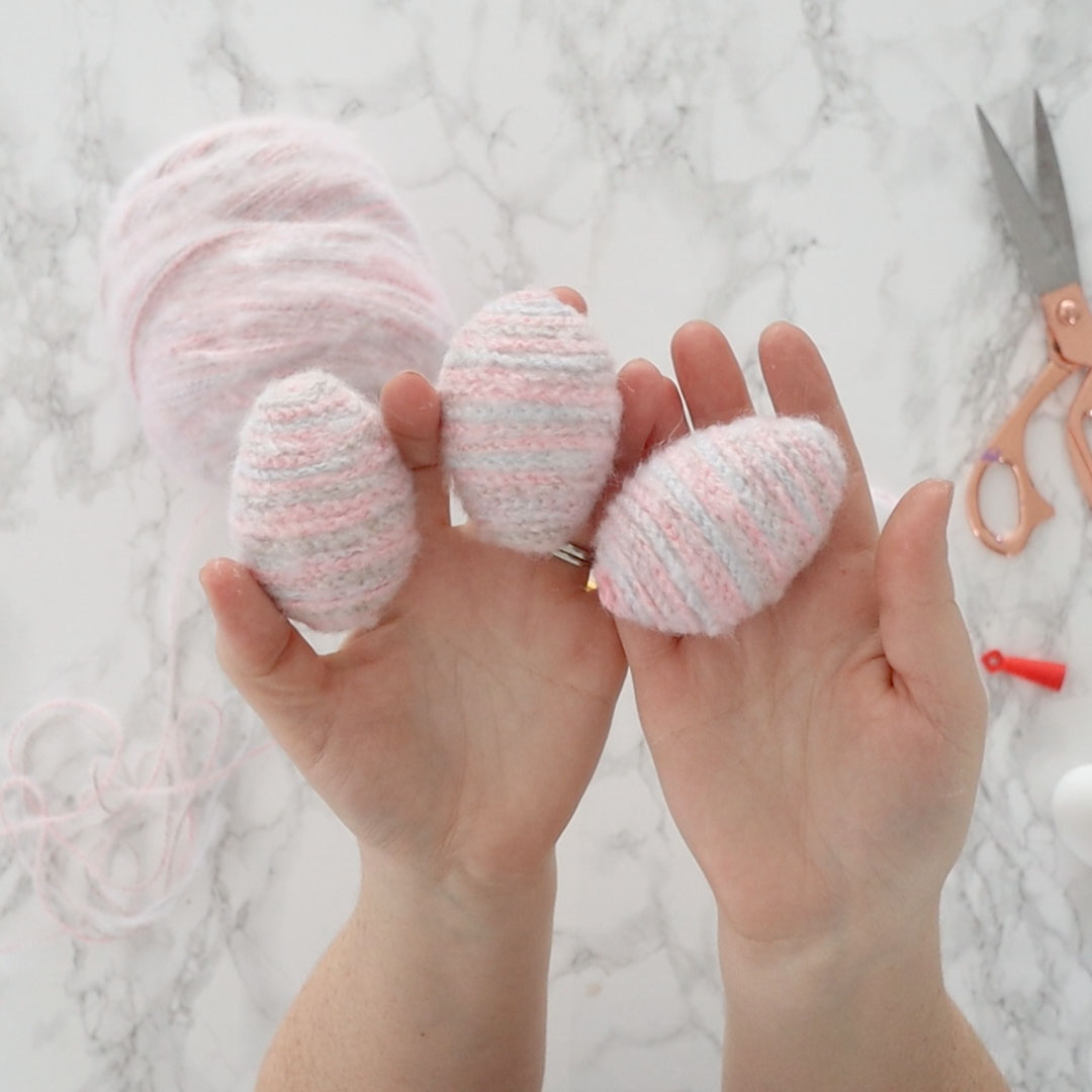 Learn how to make adorable, fuzzy Easter eggs from Dollar Store plastic eggs and crochet chains.