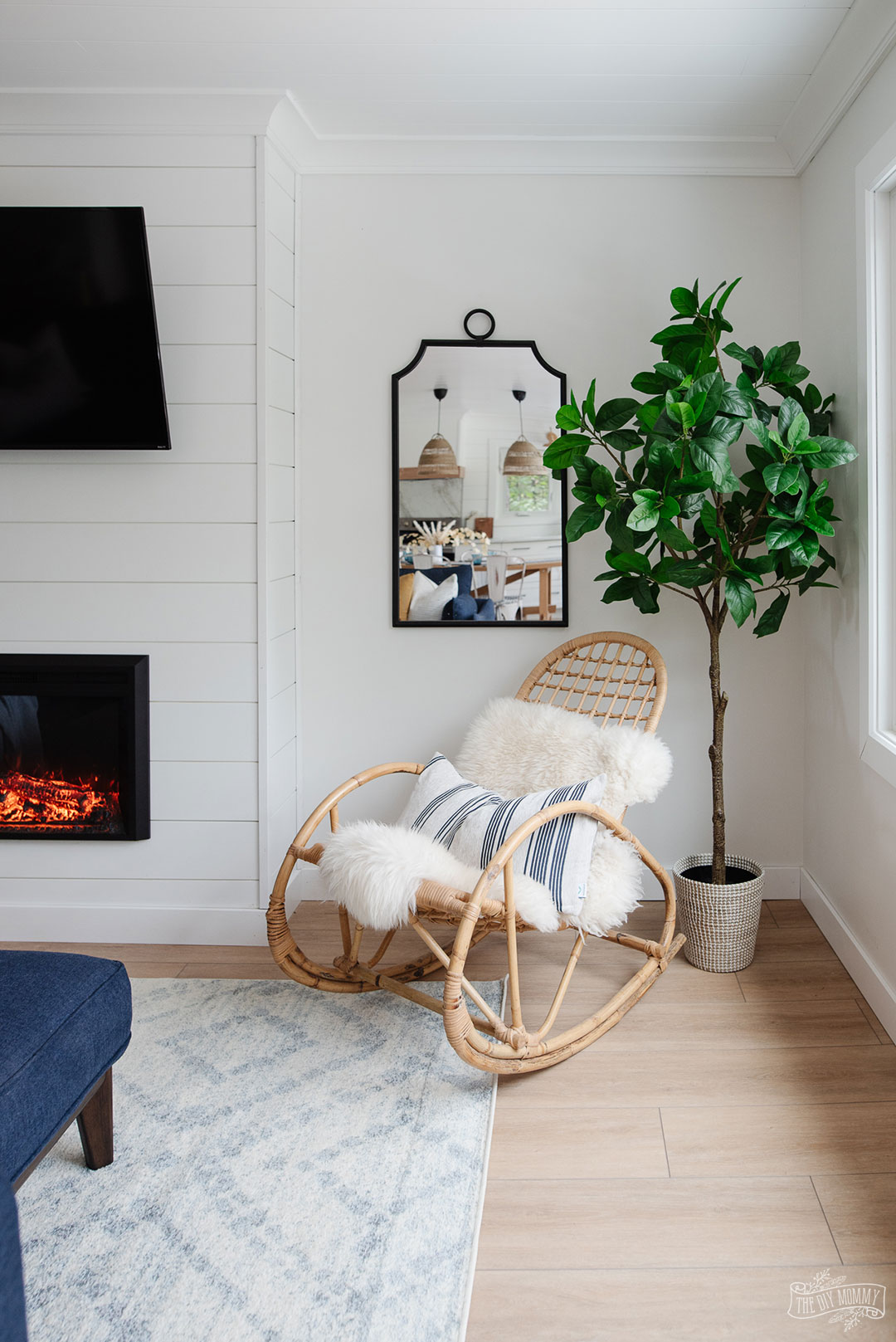 See how a boring, dated living room was transformed into a coastal modern farmhouse space with a DIY shiplap fireplace and adorable office nook with storage.