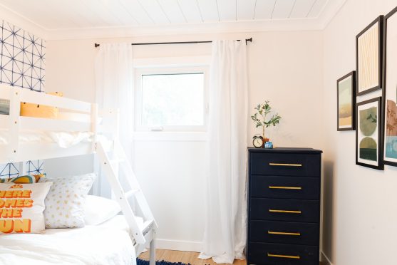Come see how a plain, dated bedroom was transformed into a bright and cheerful bedroom with a bunk bed and blue, yellow and white colors
