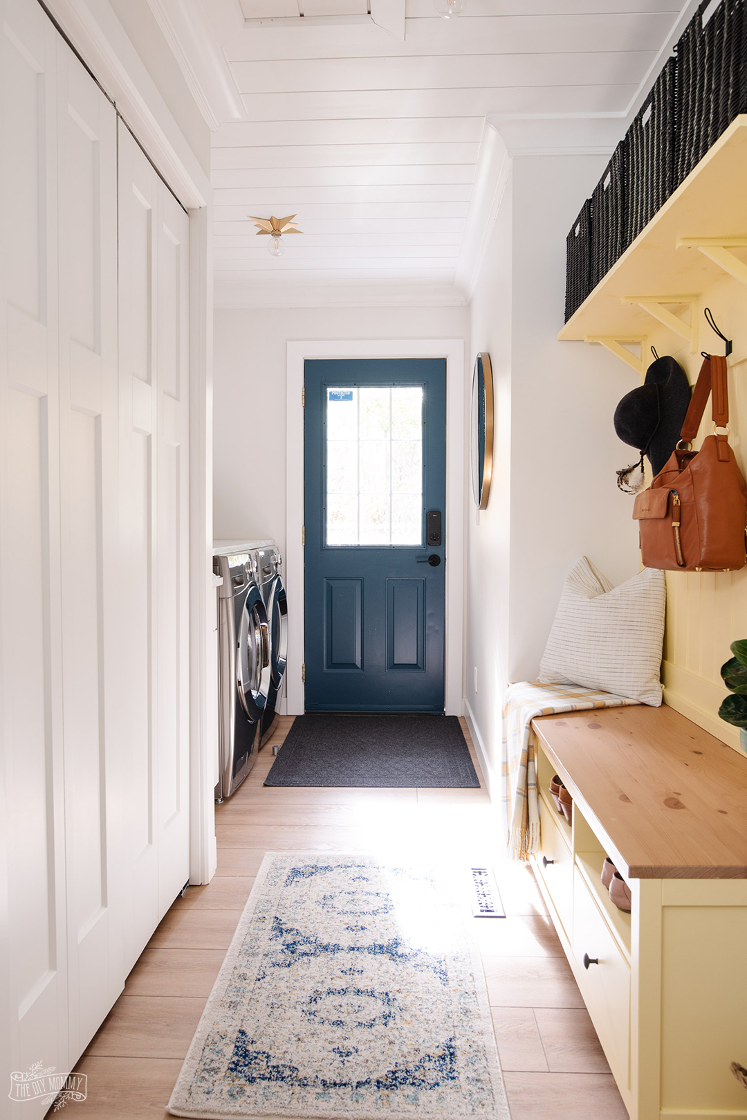 See how we transformed a tiny entryway into a cheerful combination mudroom and laundry room