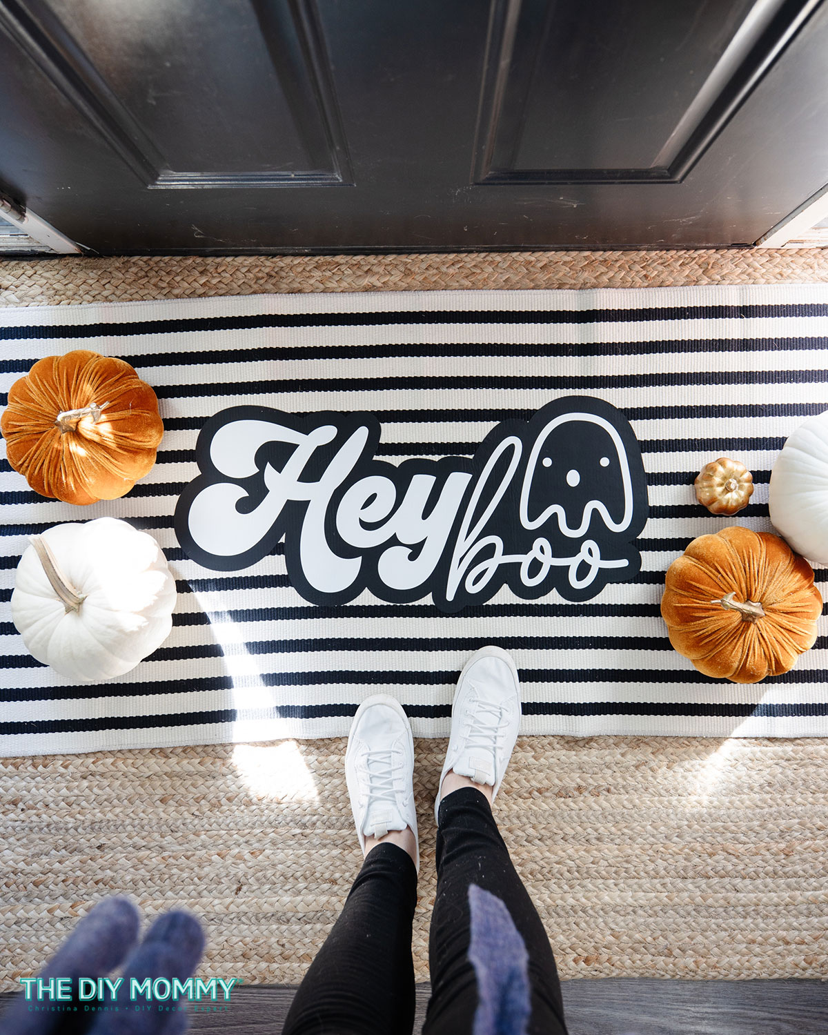 DIy Halloween porch door mat.  Made with a Cricut.  Decal on the mat has a little black ghost and says HEY Boo