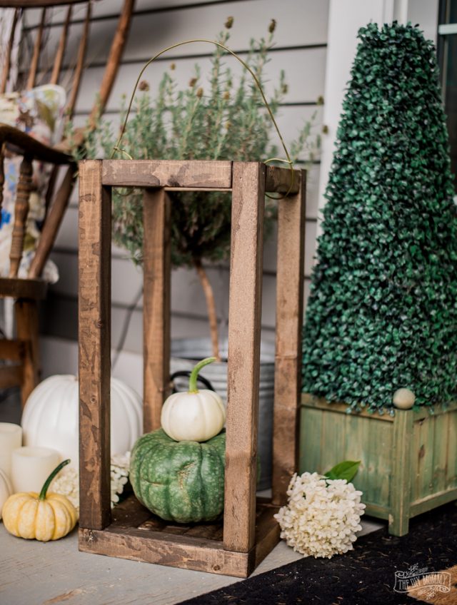 Rustic Wooden Lantern on porch with green orange and white pumpkins