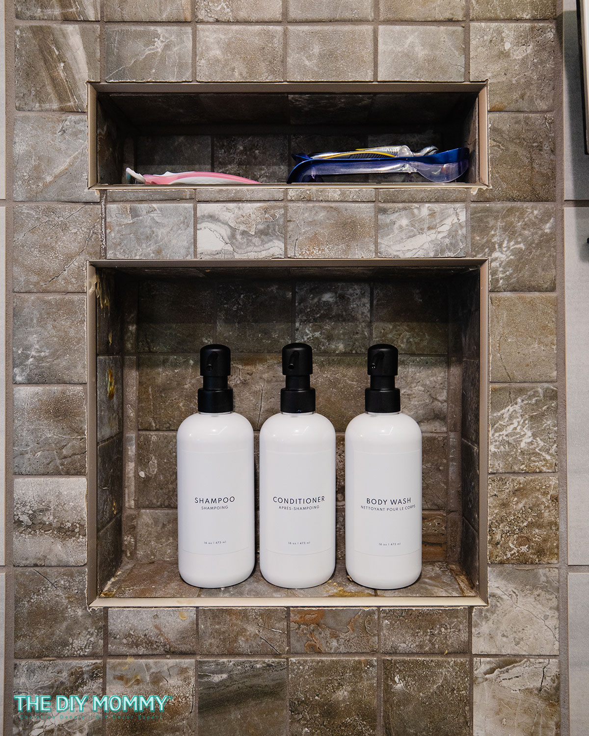 A set of 3 white soap/shampoo dispensing bottles with black pumps displayed in a shower. Could also be used as kitchen soap dispensers
