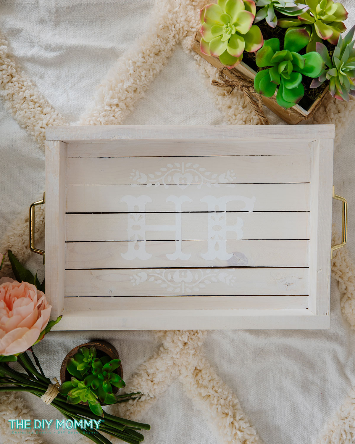 A whitewashed wooden tray has been monogrammed with the letters H F in white for a subtle look. 